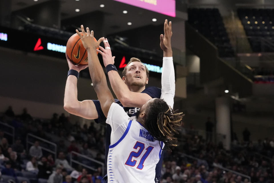 Xavier's Jack Nunge shoots over DePaul's Da'Sean Nelson (21) during the first half of an NCAA college basketball game Wednesday, Jan. 18, 2023, in Chicago. (AP Photo/Charles Rex Arbogast)