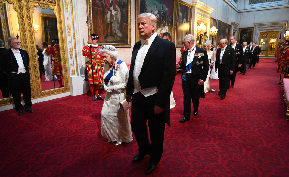 Queen Elizabeth II, US President Donald Trump and the Prince of Wales arrive through the East Gallery during the State Banquet at Buckingham Palace, London, on day one of the US President's three day state visit to the UK.