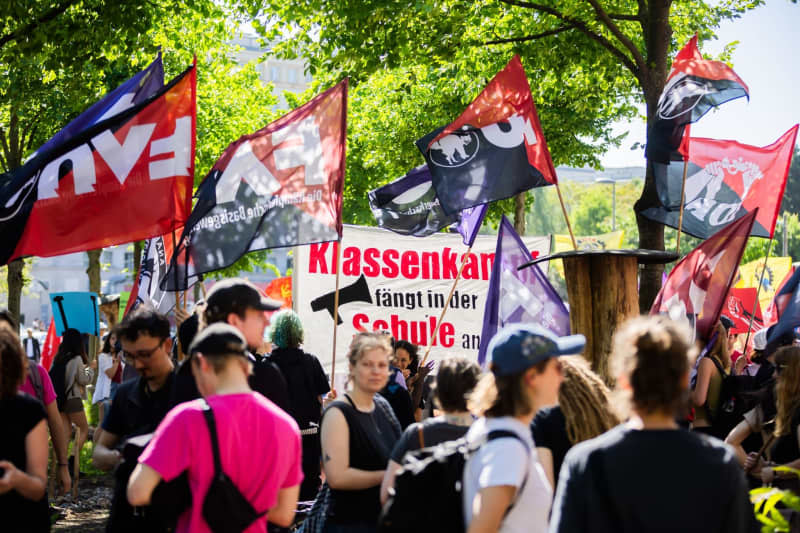 People take part in a demonstration organized by the German Trade Union Confederation (DGB) on May Day at Karl-Marx-Allee. Christoph Soeder/dpa