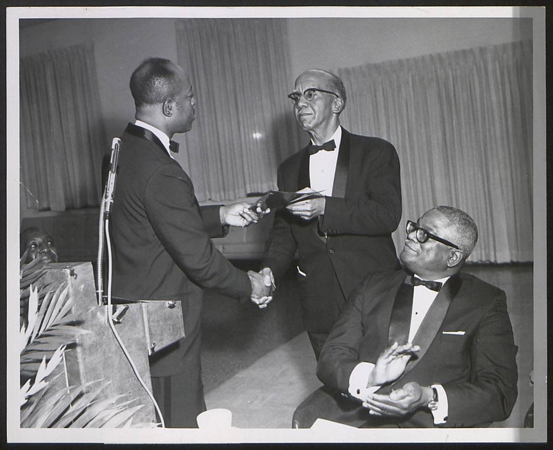 Pictured here President Prezell Robinson (left), Dr. Bayer (center), seated person unidentified.