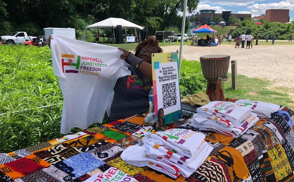 Hopewell Juneteenth Freedom Festival volunteer Shala Gray of Richmond sells t-shirts on June 18, 2022.