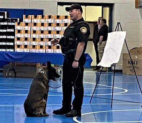 Sgt. Brian Bernhart along with his dog Diego of the Holmes County Sheriff's Office K-9 Unit speaks during a bike safety assembly last week at Chestnut Ridge Elementary.