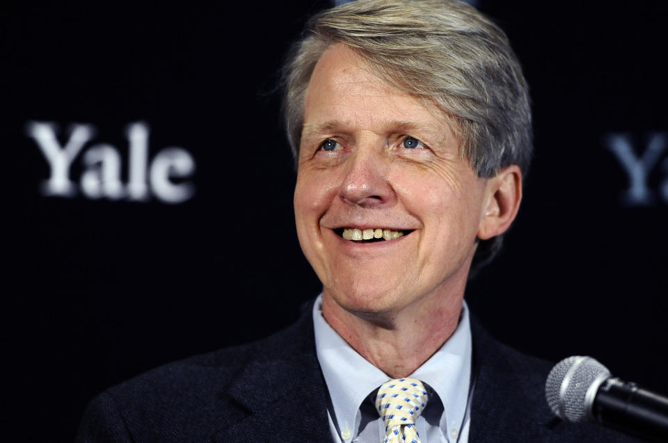 FILE - In this Oct. 14, 2013 file photo, Nobel prize-winning Yale University economist Robert Shiller smiles at a news conference in New Haven, Conn. In his new book with George Akerlof, another Nobel-prize winning economist, Shiller examines the many ways credit-card companies, financial firms and other businesses lure people into buying things that might harm them. (AP Photo/Jessica Hill, File)