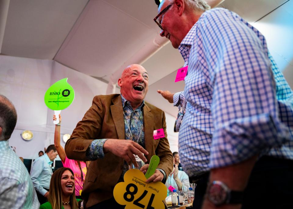 John Van Hulle celebrates winning an auction lot during the Naples Winter Wine Fest at The Ritz-Carlton Naples, Tiburón, in Naples on Saturday, Jan. 27, 2024.