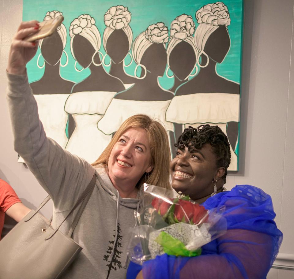 Amy Painter takes a selfie with Semeion Richardson at the grand opening of the Artist with a Purpose gallery in downtown Leesburg on Saturday, Jan. 22, 2022. [PAUL RYAN / CORRESPONDENT]