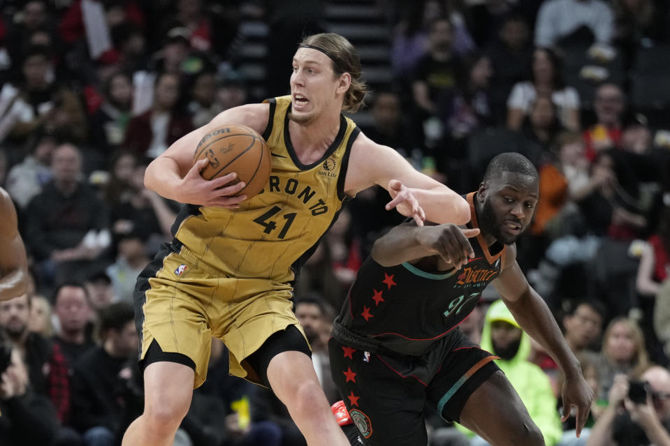 Toronto Raptors forward Kelly Olynyk (41) steals the ball from Washington Wizards forward Eugene Omoruyi (97) during the first half of an NBA basketball game in Toronto on Sunday, April 7, 2024. (Frank Gunn/The Canadian Press via AP)