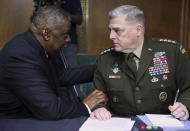 Secretary of Defense Lloyd Austin, left, and Chairman of the Joint Chiefs Chairman Gen. Mark Milley talk before a Senate Appropriations Committee hearing to examine proposed budget estimates and justification for fiscal year 2022 for the Department of Defense in Washington on Thursday, June 17, 2021. (Evelyn Hockstein/Pool via AP)