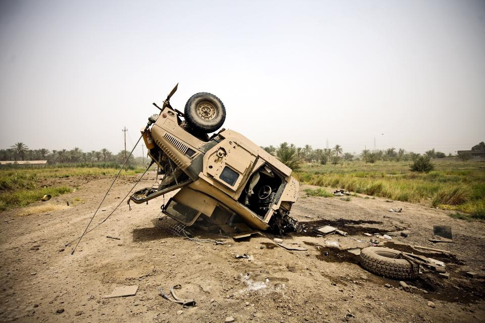 A US vehicle wrecked by IEDs, Iraq.