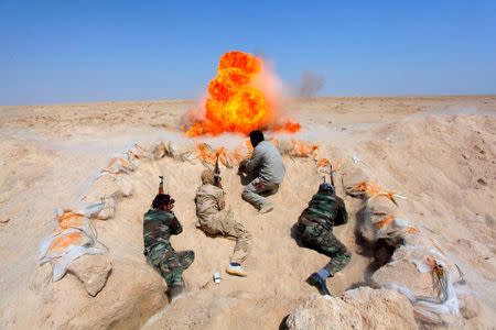 Shi'ite fighters, who have joined the Iraqi army to fight against militants of the Islamic State, formerly known as the Islamic State of Iraq and the Levant, take part in field training in the desert in the province of Najaf, September 16, 2014. REUTERS/Alaa Al-Marjani