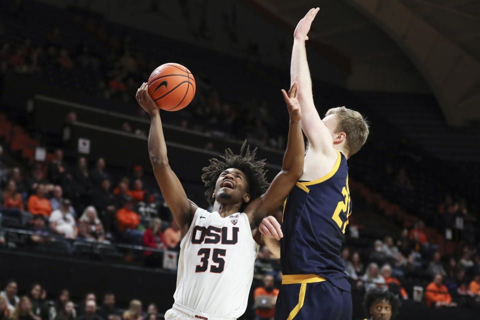 California forward Lars Thiemann, right, tries to block a shot by Oregon State forward Glenn Taylor Jr. (35) during the first half of an NCAA college basketball game in Corvallis, Ore., Saturday, March 4, 2023. (AP Photo/Amanda Loman)