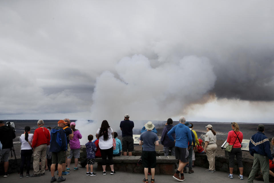 <p>Visitors watch as steam and gas rise from Kilauea’s summit crater in Volcanoes National Park, Hawaii, Wednesday, May 9, 2018. (Photo: Jae C. Hong/AP) </p>