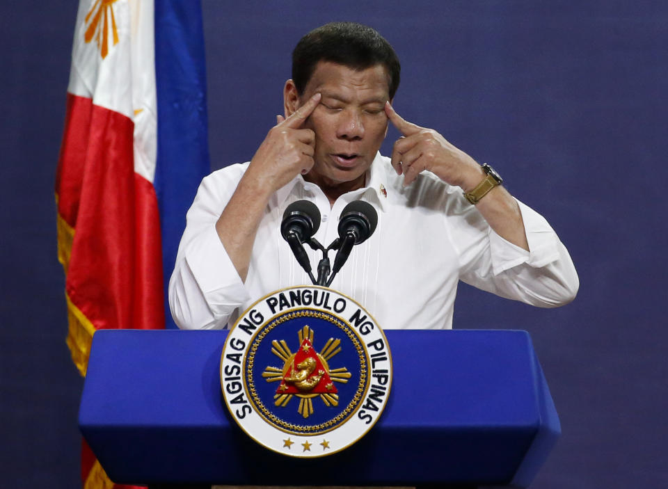 FILE - Philippine President Rodrigo Duterte gestures as he addresses land reform beneficiaries on the 31st year of the implementation of the Comprehensive Agrarian Reform Program (CARP) in suburban Quezon city northeast of Manila, Philippines, Tuesday, Aug. 27, 2019. The Philippine government has asked the International Criminal Court to defer its crimes against humanity investigation linked to the country's "war on drugs," the court's chief prosecutor announced Tuesday, Nov. 23, 201. The request will delay the international probe into the deadly crackdown. (AP Photo/Bullit Marquez, File)