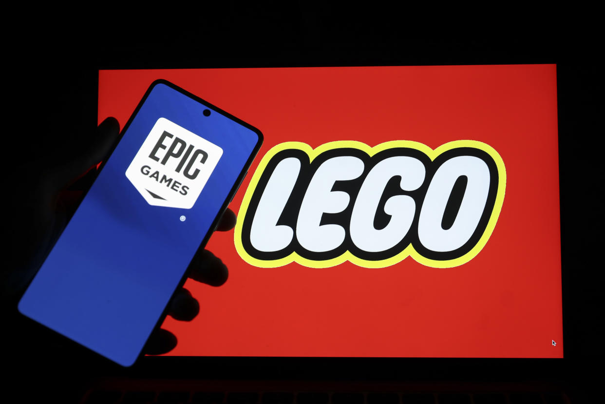 ANKARA, TURKIYE - APRIL 12: In this photo illustration, the logo of Lego is displayed on computer screen and the logo of Epic Games is displayed on the phone screen in front of it, in Ankara, Turkiye on April 12, 2022. Muhammed Yaylali / Anadolu Agency