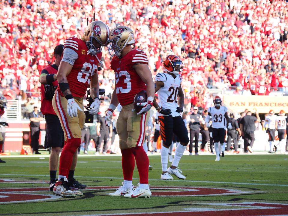 Oct 29, 2023; Santa Clara, California, USA; San Francisco 49ers tight end George Kittle (85) and running back Christian McCaffrey (23) put their helmets together after McCaffrey scored a touchdown against the Cincinnati Bengals during the fourth quarter at Levi's Stadium. Mandatory Credit: Kelley L Cox-USA TODAY Sports