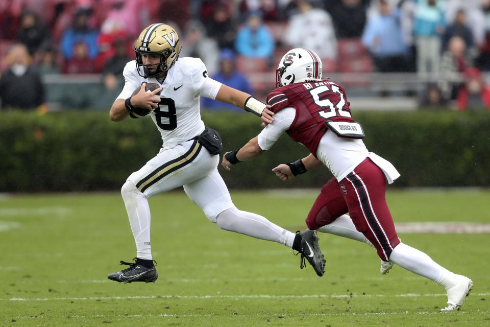 Vanderbilt quarterback Ken Seals (8) runs past South Carolina linebacker Stone Blanton (52) during the first half of an NCAA college football game on Saturday, Nov. 11, 2023, in Columbia, S.C. (AP Photo/Artie Walker Jr.)