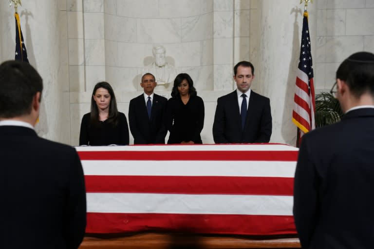 US President Barack Obama and US First Lady Michelle Obama pay their respects as US Supreme Court Justice Antonin Scalia’s body lies in repose at the Supreme Court on February 19, 2016 in Washington, DC