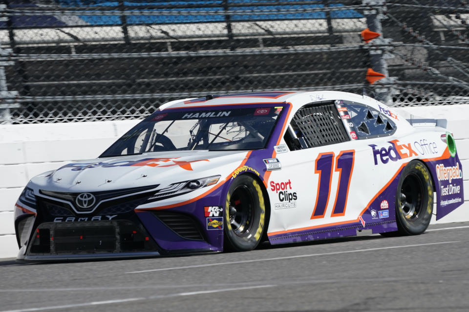 wld Denny Hamlin (11) approaches the third turn during the NASCAR Cup Series auto race at Martinsville Speedway in Martinsville, Va., Sunday, April 11, 2021. (AP Photo/Steve Helber)