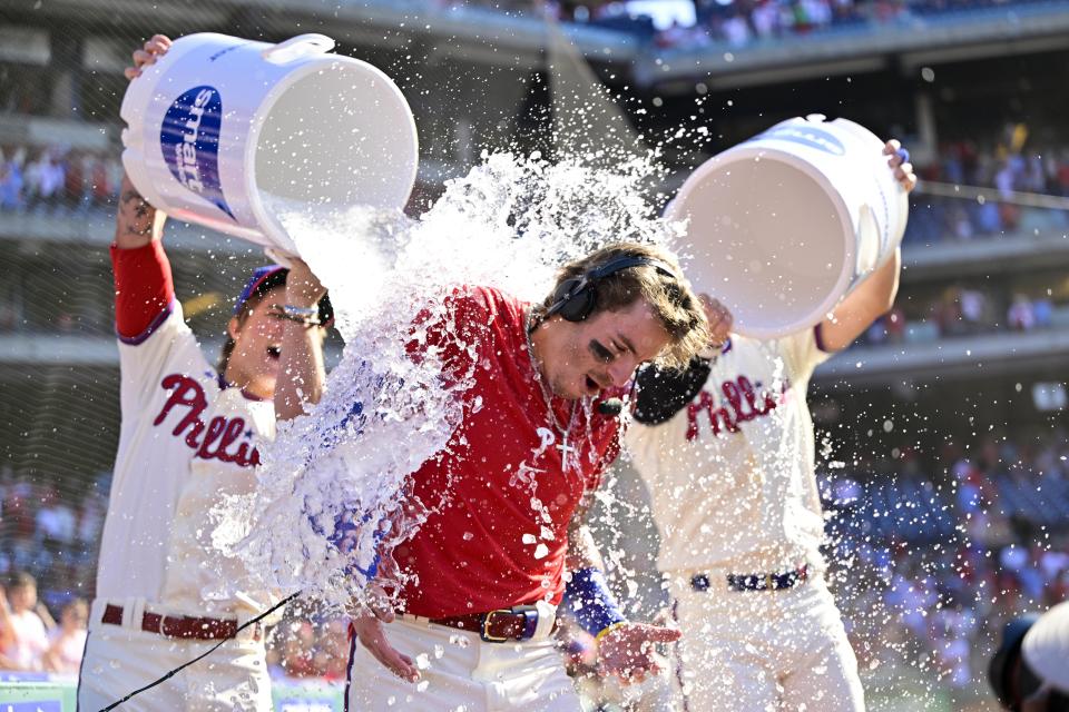 Philadelphia Phillies' Bryson Stott is doused by teammates after hitting a walk-off three run home run during the ninth inning of a baseball game off Los Angeles Angels' Jimmy Herget, Sunday, June 5, 2022, in Philadelphia. (AP Photo/Derik Hamilton)