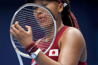 Naomi Osaka, of Japan, adjusts her racket during a second round tennis match against Viktorija Golubic, of Switzerland, at the 2020 Summer Olympics, Monday, July 26, 2021, in Tokyo, Japan. (AP Photo/Patrick Semansky)