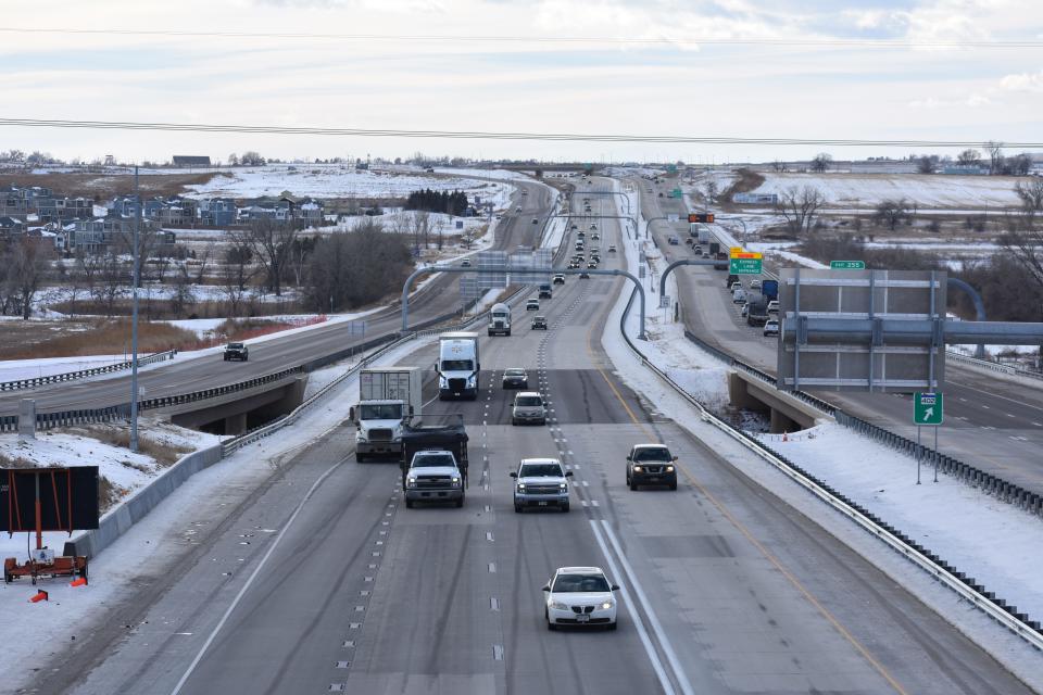 Vehicles drive on Interstate 25 near Loveland on Jan. 18. Striping is shown indicating when vehicles can exit the toll lane, noted by dashed lines, and when vehicles need to stay in the lane, noted by double solid lines.
