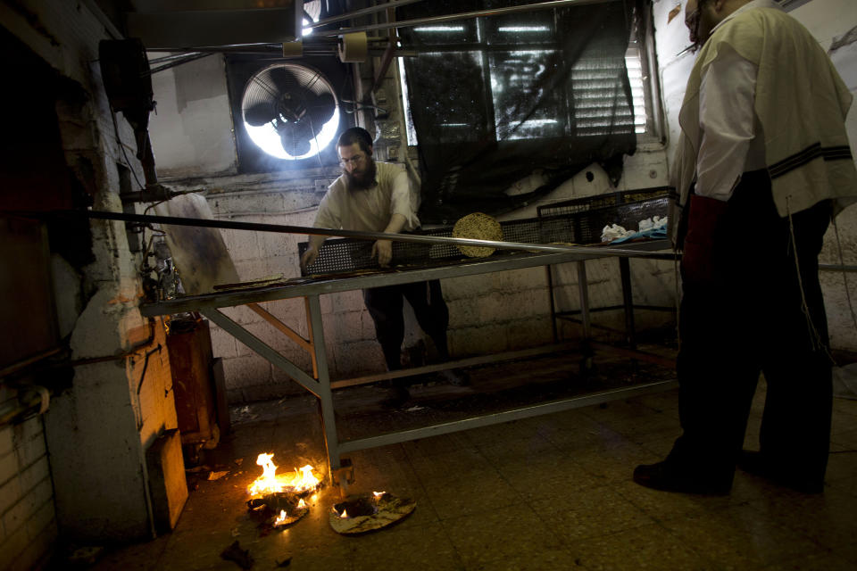 Ultra-Orthodox Jews prepare special matzoh, a traditional handmade Passover unleavened bread, at a bakery in Bnei Brak near Tel Aviv, Israel. Thursday, April 10, 2014. Jews are forbidden to eat leavened foodstuffs during the Passover holiday. Passover celebrates the biblical story of the Israelites' escape from slavery and exodus from Egypt. (AP Photo/Oded Balilty)