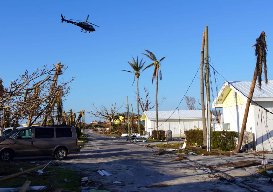 Sep 7, 2019; Treasure Cay, Bahamas; A helicopter flies over homes damaged by Hurricane Dorian on Treasure Cay in The Bahamas.