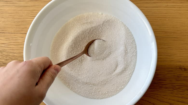 spoon mixing sugar in bowl