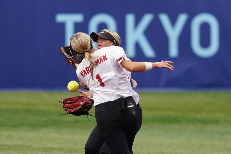 Canada's Kelsey Harshman, left, and Jennifer Gilbert collide while trying to catch a pop up during a softball game against Italy at Yokohama Baseball Stadium during the 2020 Summer Olympics, Monday, July 26, 2021, in Yokohama, Japan. (AP Photo/Matt Slocum)