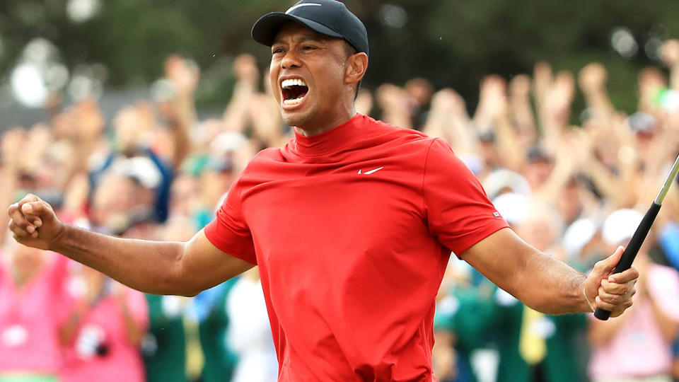 Tiger Woods celebrates after sinking his putt to win. (Photo by Andrew Redington/Getty Images)