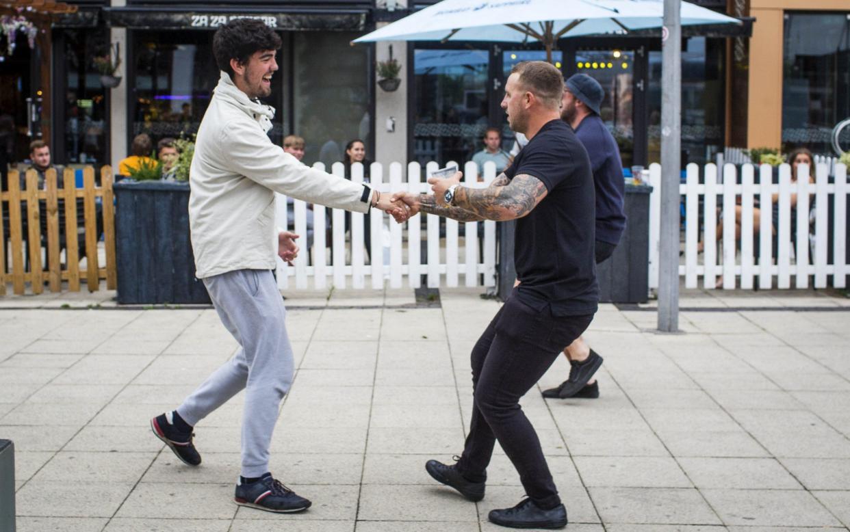 July 4 saw dancing on the streets, as lockdown finally eased. Tomorrow is likely to be a more sombre occasion - SWNS