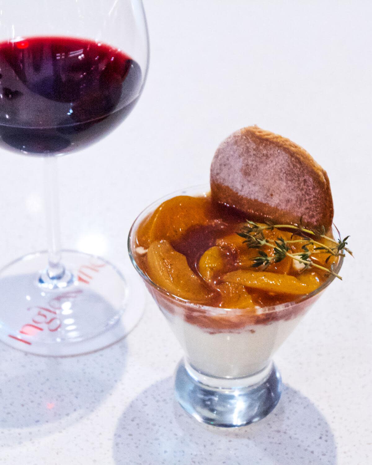 Peach cobbler and a glass of red wine at Inglewood's 1010 Wine and Events