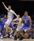 Kentucky's Aaron Harrison (2) steals the ball from Louisville's Luke Hancock (11) during the first half of an NCAA Midwest Regional semifinal college basketball tournament game Friday, March 28, 2014, in Indianapolis. (AP Photo/David J. Phillip)