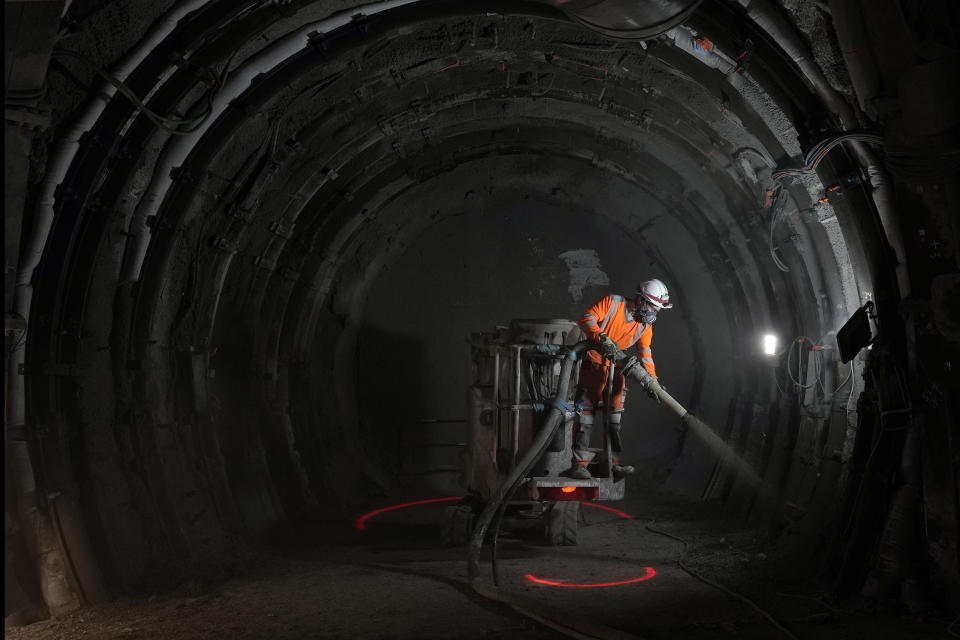 A worker sprays a layer of cement protection in a tunnel for radioactive waste in an underground laboratory run by Andra, an agency that manages the waste, in Bure, eastern France, Thursday, Oct. 28, 2021. Nuclear power is a central sticking point as negotiators plot out the world’s future energy strategy at the climate talks in Glasgow, Scotland. (AP Photo/Francois Mori)