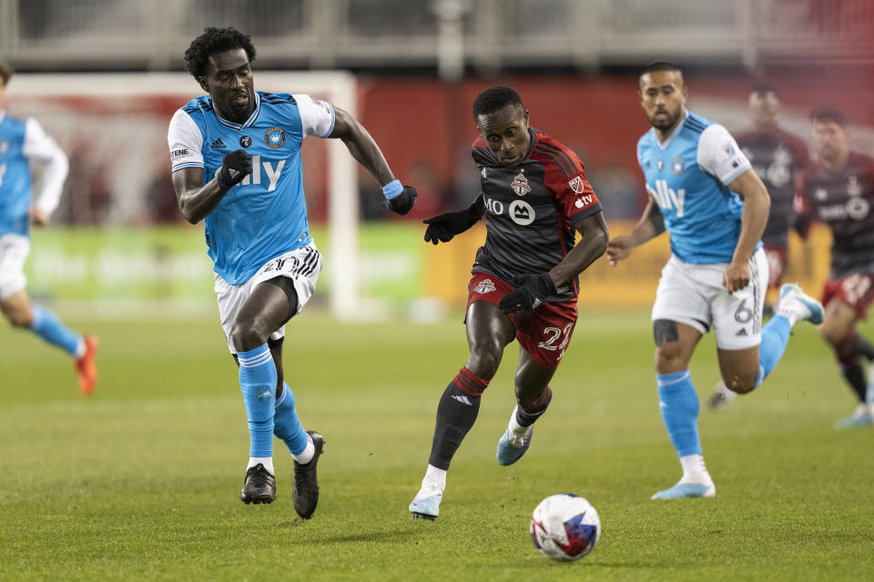Toronto FC midfielder Richie Laryea (22) and Charlotte FC midfielder Derrick Jones (20) chase the ball during the first half of an MLS soccer match Saturday, April 1, 2023, in Vancouver, British Columbia. (Andrew Lahodynskyj/The Canadian Press via AP)