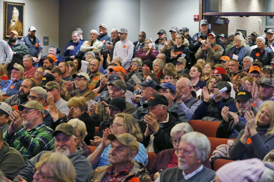 Spectators applaud after the Buckingham County Board of Supervisors unanimously votes to pass a Second Amendment sanctuary resolution at a meeting in Buckingham, Va., Dec. 9, 2019. <a href="https://newsroom.ap.org/detail/GunSanctuariesVirginia/dfa46843d6df44f799a5a408248a4f0a/photo?Query=Second%20Amendment%20Sanctuary&mediaType=photo&sortBy=arrivaldatetime:desc&dateRange=Anytime&totalCount=14&currentItemNo=12" rel="nofollow noopener" target="_blank" data-ylk="slk:AP Photo/Steve Helber;elm:context_link;itc:0;sec:content-canvas" class="link ">AP Photo/Steve Helber</a>