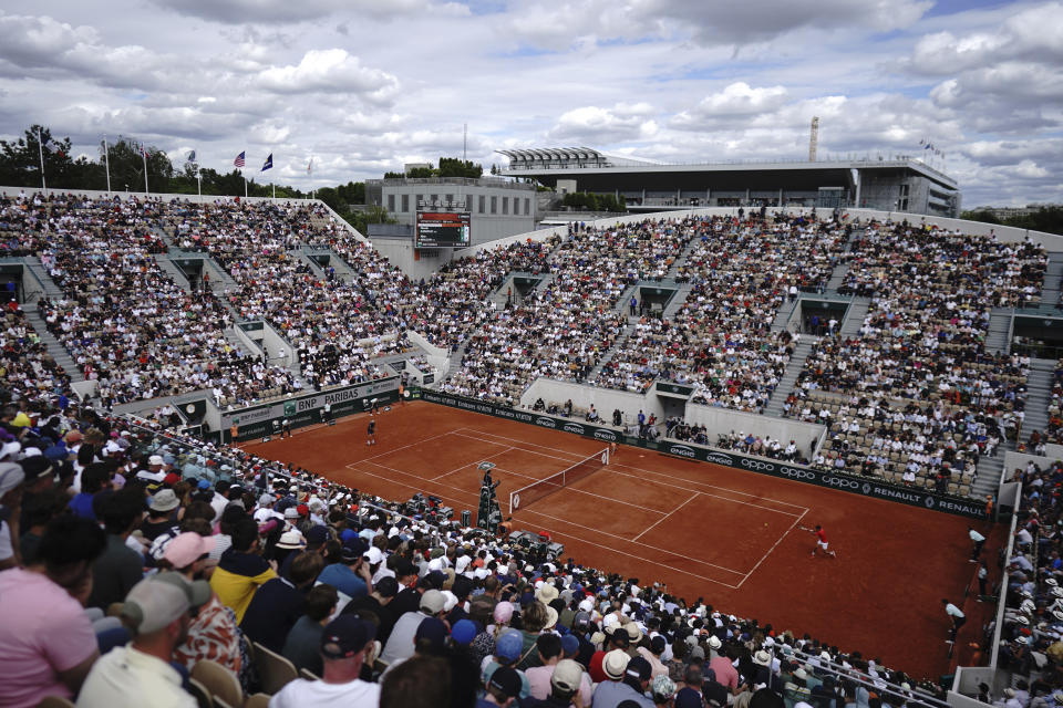 Serbia's Novak Djokovic, right, returns the ball to Slovakia's Alex Molcan during their second round match of the French Open tennis tournament at the Roland Garros stadium Wednesday, May 25, 2022 in Paris. (AP Photo/Thibault Camus)