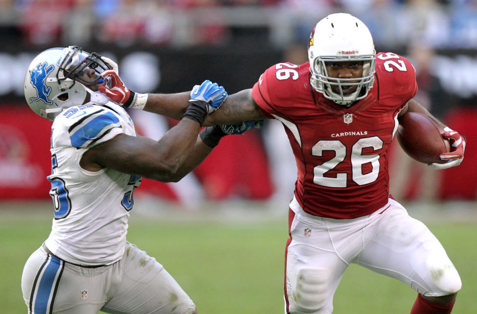 Arizona Cardinals running back Beanie Wells (26) stiff-arms Detroit Lions middle linebacker Stephen Tulloch (55) during the second half of an NFL football game on Sunday, Dec. 16, 2012, in Glendale, Ariz. (AP Photo/Paul Connors)