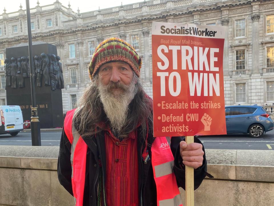 Striking postal worker Andy Coldwell (59) at Parliament Square rally on 9 December 2022. (Mustafa Qadri/The Independent)