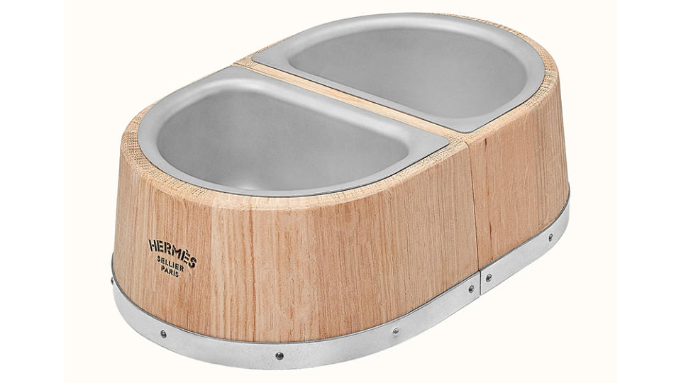 The Hermès dog bowl made from oak wood with stainless steel bowls. - Credit: Hermès