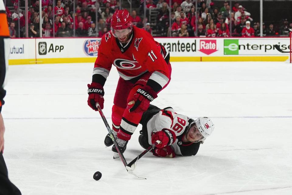 May 3, 2023; Raleigh, North Carolina, USA; Carolina Hurricanes center Jordan Staal (11) goes after the puck against New Jersey Devils center Jack Hughes (86) during the third period in game one of the second round of the 2023 Stanley Cup Playoffs at PNC Arena. Mandatory Credit: James Guillory-USA TODAY Sports