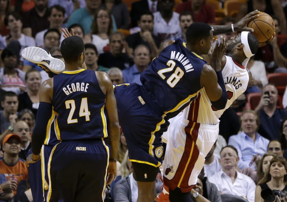 Miami Heat's LeBron James, right, is fouled by Indiana Pacers' Ian Mahinmi (28) during the first half of an NBA basketball game, Friday, April 11, 2014, in Miami. (AP Photo/Lynne Sladky)