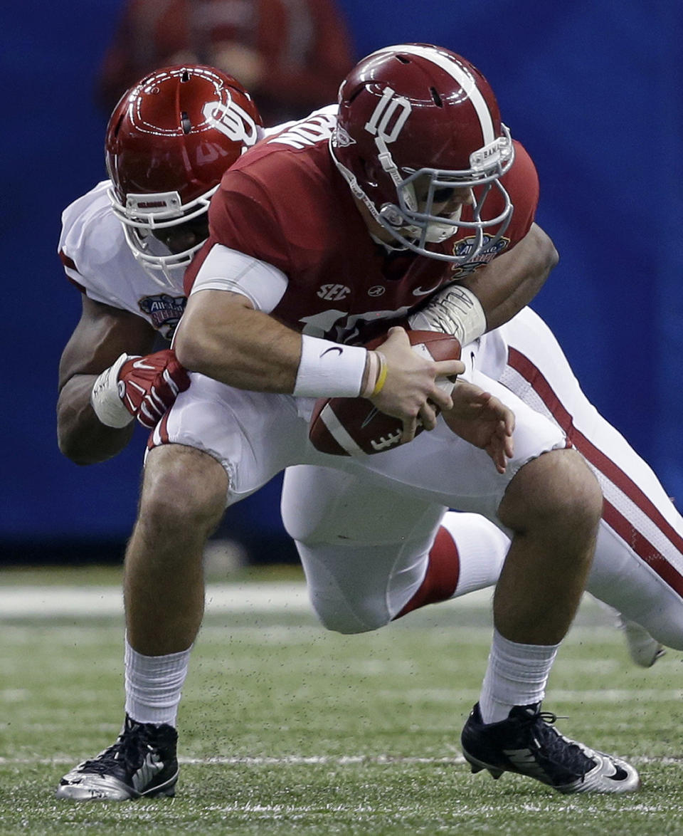 Alabama quarterback AJ McCarron (10) is sacked by Oklahoma defensive end Geneo Grissom during the first half of the Sugar Bowl NCAA college football game, Thursday, Jan. 2, 2014, in New Orleans. (AP Photo/Patrick Semansky)