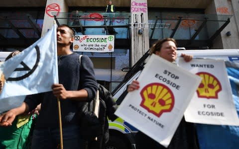 Protesters outside the Shell headquarters in London - Credit: Andy Rain/REX