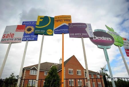 Residential property sales signs are seen on a street in west London July 12, 2008. REUTERS/Toby Melville