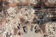 <p>OCT. 12, 2017 – In this aerial view, a burned neighborhood is seen in Santa Rosa, California.<br> Hundreds of people are still missing in massive wildfires which have swept through California killing at least 26 people and damaging thousands of homes, businesses and other buildings. (Josh Edelson/AFP/Getty Images) </p>