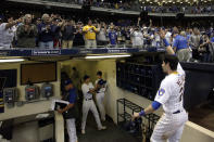 FILE - In this Sept. 7, 2019, file photo, fans cheer as Milwaukee Brewers' Christian Yelich walks off the field after driving in the winning run with a double during the ninth inning of the team's baseball game against the Chicago Cubs in Milwaukee. Major League Baseball will start each extra inning this season by putting a runner on second base. This rule has been used since 2018 in the minor leagues, where it created more action and settled games sooner. “I think it’s great,” Yelich said. “As a player, there’s nothing worse than extra innings." (AP Photo/Aaron Gash, File)