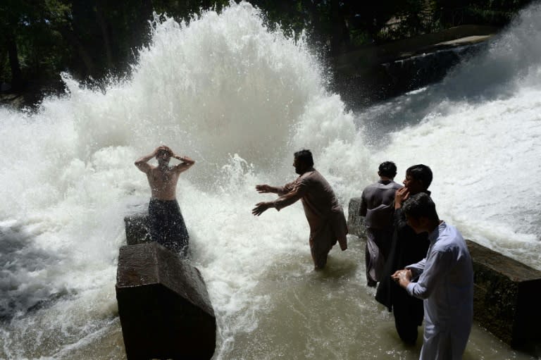 Afghan men cool off on a hot day as temperatures reached around 43 degrees Celsius (109 degrees Fahrenheit) on the first day of the Islamic holy month of Ramadan on the outskirts of Jalalabad on May 27, 2017