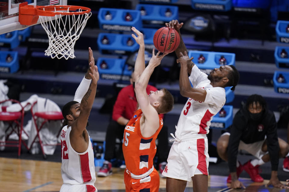 Houston guard DeJon Jarreau (3) blocks the shot of Syracuse guard Buddy Boeheim (35) as Houston forward Reggie Chaney (32) defends in the first half of a Sweet 16 game in the NCAA men's college basketball tournament at Hinkle Fieldhouse in Indianapolis, Saturday, March 27, 2021. (AP Photo/Michael Conroy)