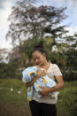 <p>Honduran migrant Genesis Martinez, 18, poses for a picture holding her two-month-old son Cesar at the sports club where they have been camping out, in Matias Romero, Oaxaca State, Mexico, Thursday, April 5, 2018. Martinez decided to join the migrant caravan after the woman she had been working for near Mexico’s southern border threw her out of the house after she gave birth.(Photo: Felix Marquez/AP) </p>