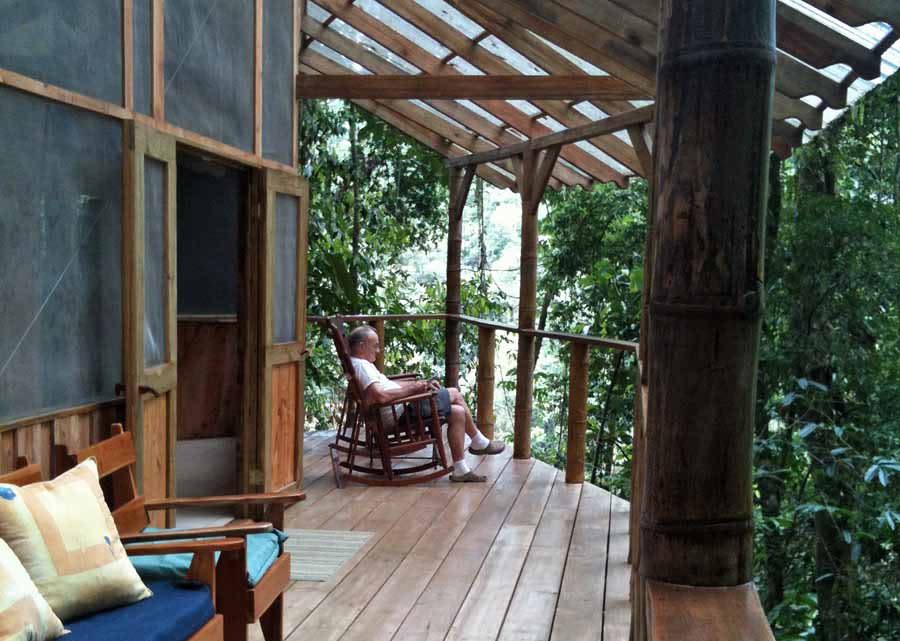 Finca Bellavista homeowner Corinne and her husband Graham completed their treehouse in 2010. Here, Corinne's father, 70, kicks back on their wrap-around porch. "I guess treehouses are for all ages," she says. "Dad even went ziplining around the property."